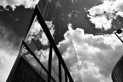 Low angle view of modern building against cloudy sky