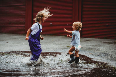 Rear view of boys and woman in water