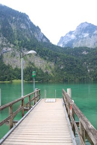 Pier over lake against mountains