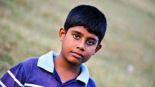 Close-up portrait teenage boy standing outdoors