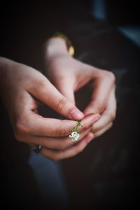 Close-up high angle view of woman holding small flower