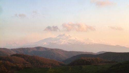 Scenic view of mountains against sky during sunset