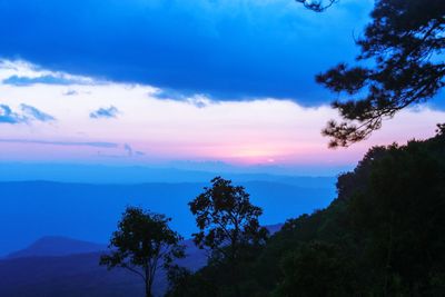 Scenic view of silhouette mountains against sky at sunset