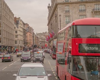 Cars in city against sky