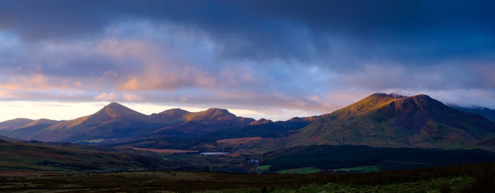 Scenic view of mountains against cloudy sky