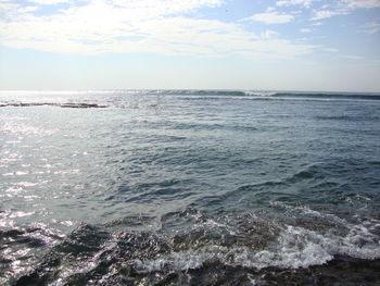 Scenic view of sea against cloudy sky