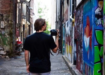 Rear view of man photographing