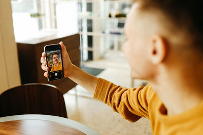 Portrait of girl photographing with mobile phone