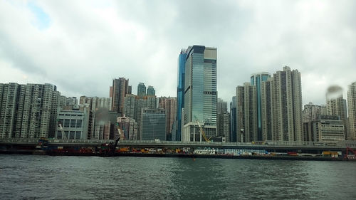 View of skyscrapers against cloudy sky