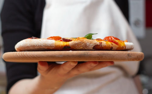 Close-up of hand holding hot dog