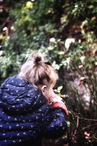 Close-up of boy against trees