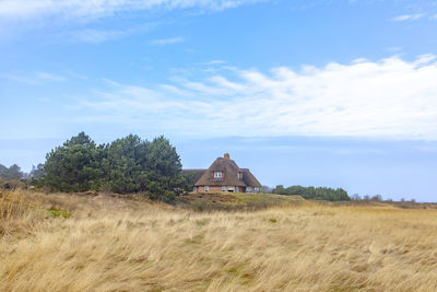 House on field against sky