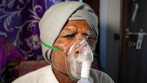 Close-up portrait of man wearing mask