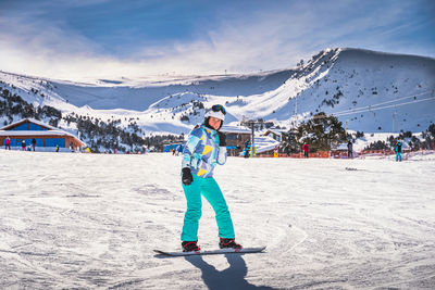 Woman, having fun and learning how to ride on a snowboard, andorra
