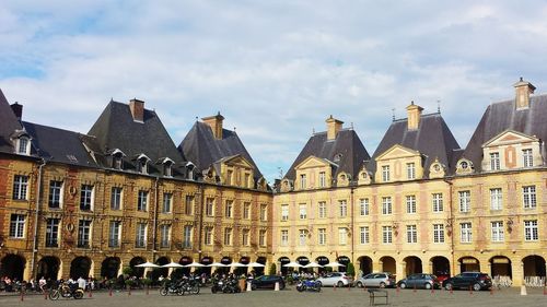 Buildings against cloudy sky