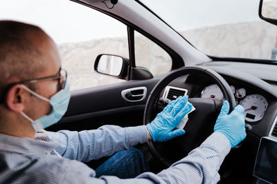 Portrait of man sitting in car