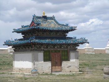 Low angle view of temple against cloudy sky