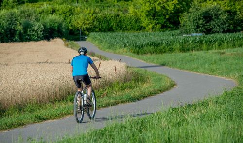 Man riding bicycle on road