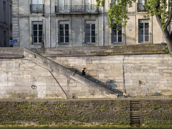 View of old building, man with a dog