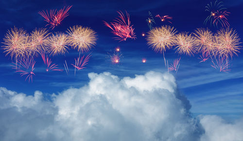 Low angle view of fireworks in sky at night