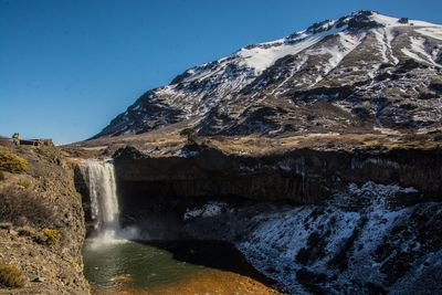 Scenic view of waterfall against sky