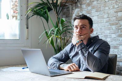 Young man using laptop at office