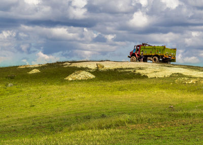 Truck on field against sky