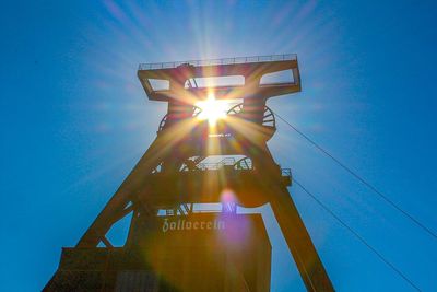 Low angle view of illuminated built structure against blue sky