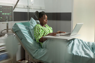 Patient using laptop at hospital