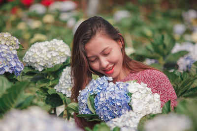 Portrait of smiling woman with flower bouquet