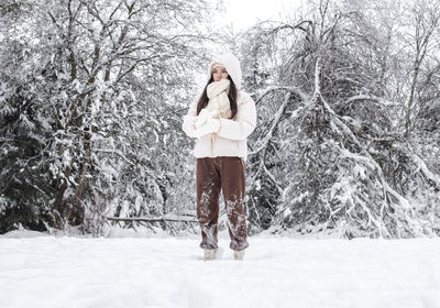 Portrait of caucasian girl in winter forest.