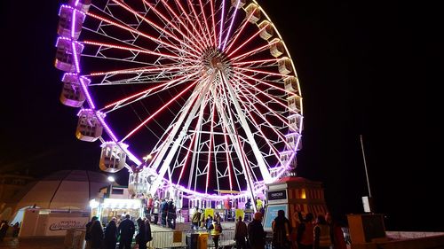 Low angle view of ferris wheel at night