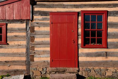 Pennsylvania log cabin exterior with red window stone step and door
