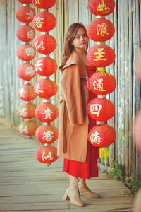 Asian woman wearing cheongsam traditional red dress on chinese new year travel.