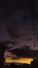 Low angle view of silhouette electricity pylon against romantic sky