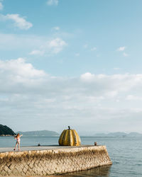 People on beach against sky