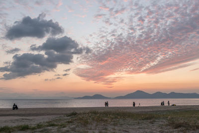 Scenic view of beach against sky during sunset