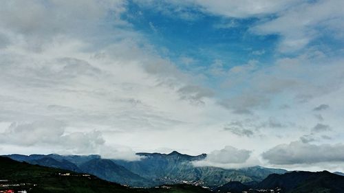 View of mountain range against cloudy sky