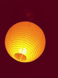 Low angle view of illuminated lamp hanging on ceiling