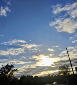 Low angle view of silhouette trees against sky