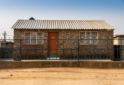 Facade of old building against clear sky