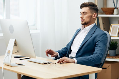 Portrait of businessman working at desk in office