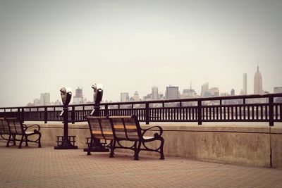 Rear view of woman walking on bridge over river