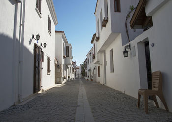 Empty narrow alley amidst buildings in town