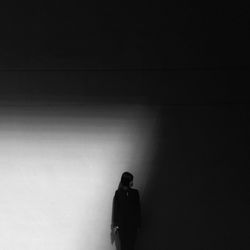 Woman standing in the dark