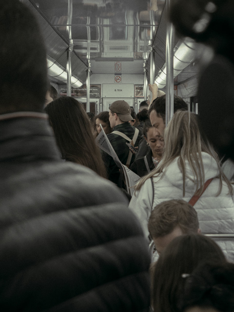 group of people, crowd, adult, women, indoors, large group of people, transportation, men, mode of transportation, public transportation, vehicle interior, rail transportation, travel, rear view, train, selective focus, group, passenger, architecture, person, journey