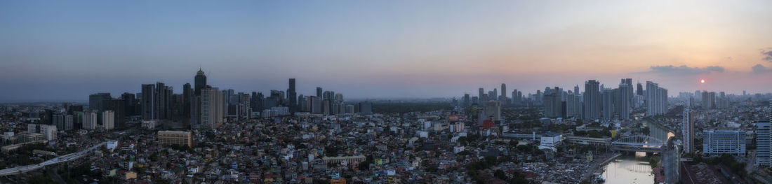 High angle view of modern buildings against sky during sunset