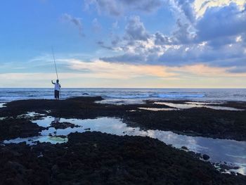 Scenic view of sea against cloudy sky