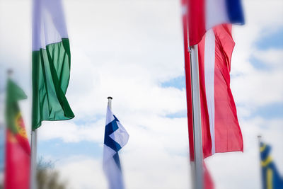 Low angle view of flags hanging against sky