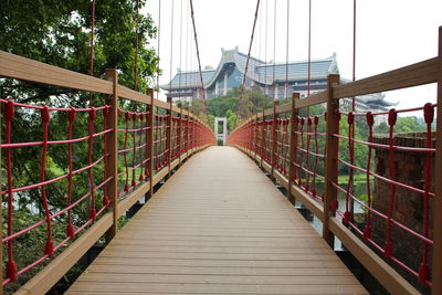 Surface level of footbridge against clear sky